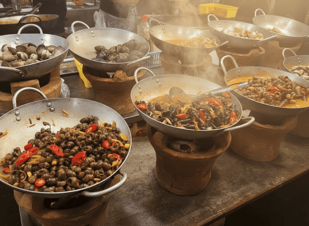 A variety of snails prepared in different ways, from stir-fried with lemongrass and chili to simmered in coconut sauce